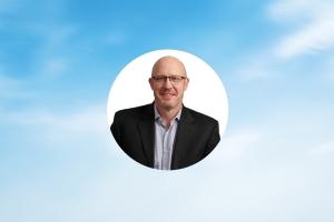 Blue sky in background with photo of Jeff Wollard, Velocity Global's Chief Financial Officer